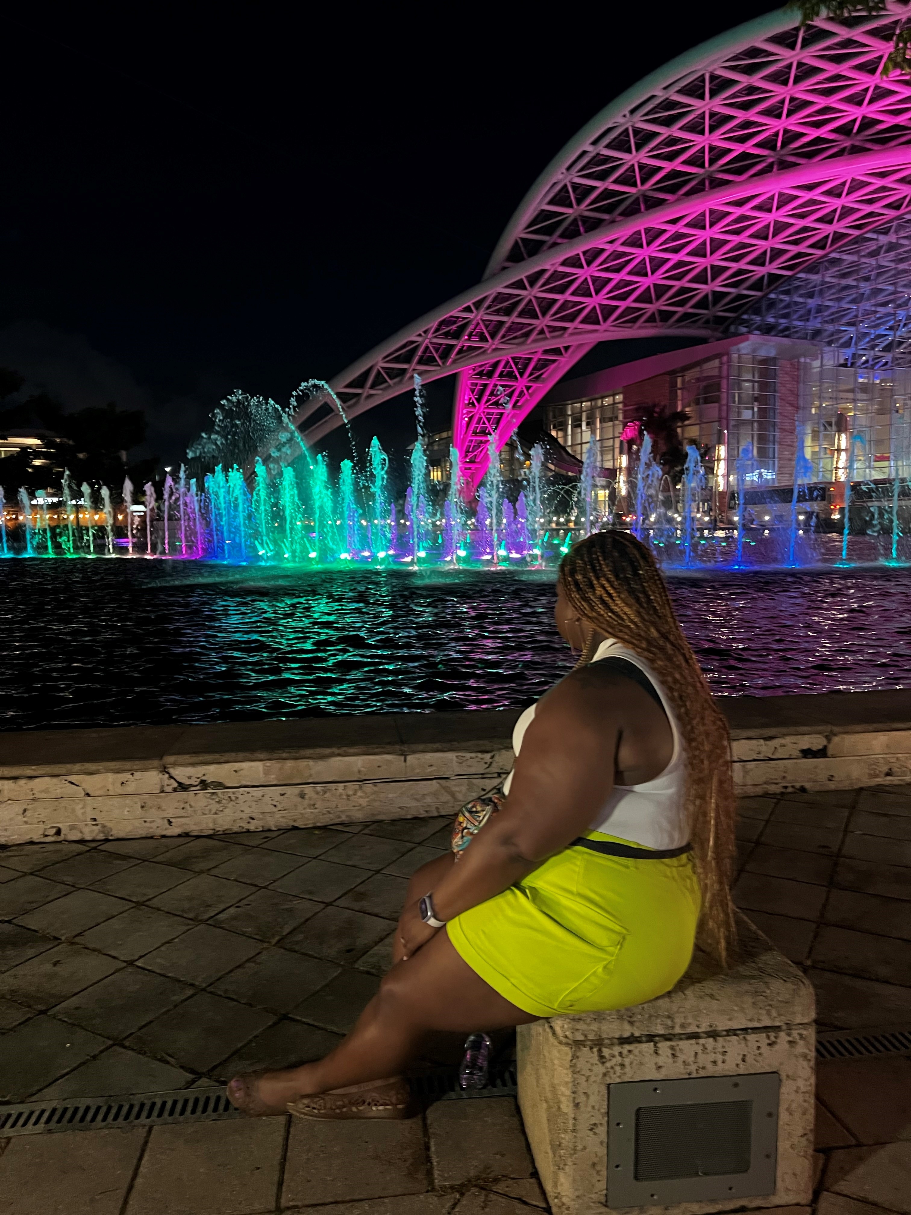 Kimberly Canady sitting outside the Puerto Rico Convention Center at night.