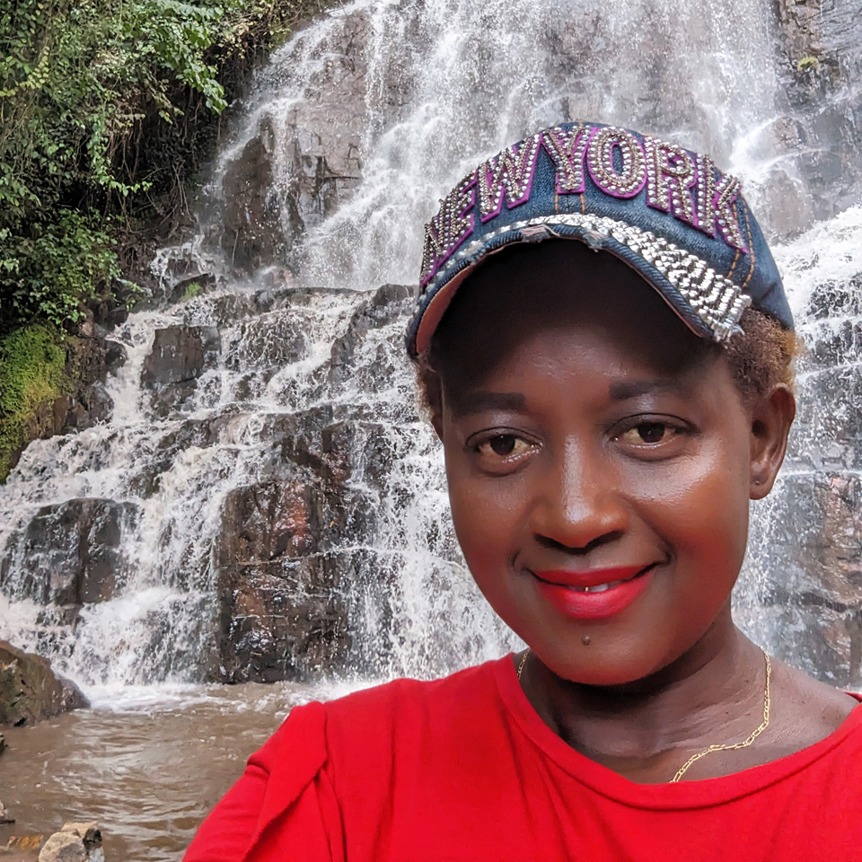 Blogger Eliane (HIVstigmafighter) in front of a waterfall.