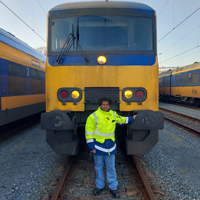 Blogger Eliane's son standing in front of a train.