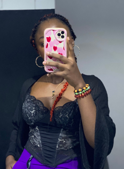 A Girl Like Me Blogger Larissa (@Mina) holding phone in front of her face.