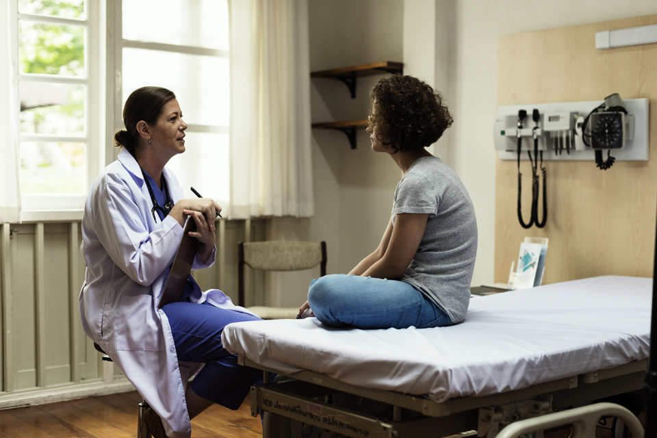 Health care provider and patient talking.