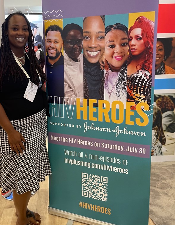 Ciarra "Ci Ci" Covin next to poster for HIV Heroes.