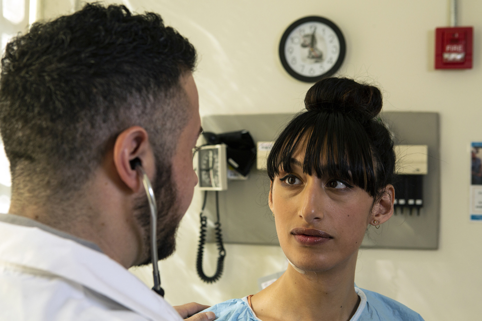 Close up of medical professional talking to a patient.