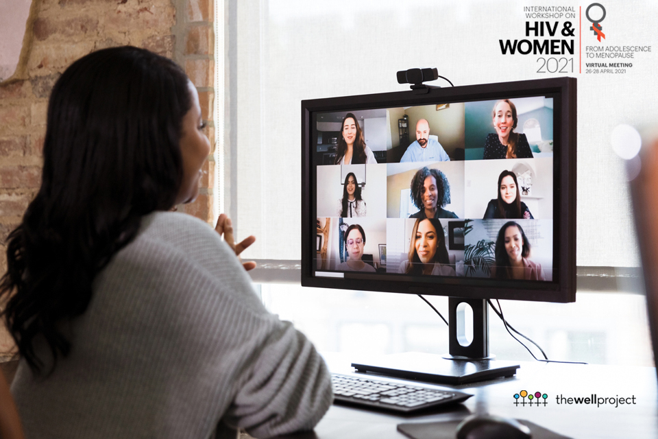 Side ack view of woman sitting at desk looking at computer screen with zoom squares.