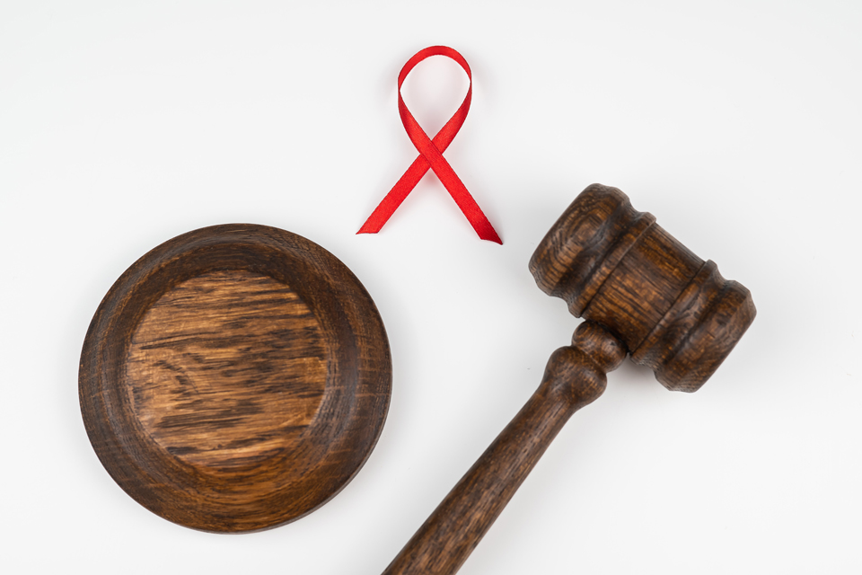 Judicial gavel and red ribbon on a white background.
