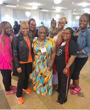 Kim (far left), Ci Ci (far right), Lynette (with goddaughter), and friends at the Iris House summit.