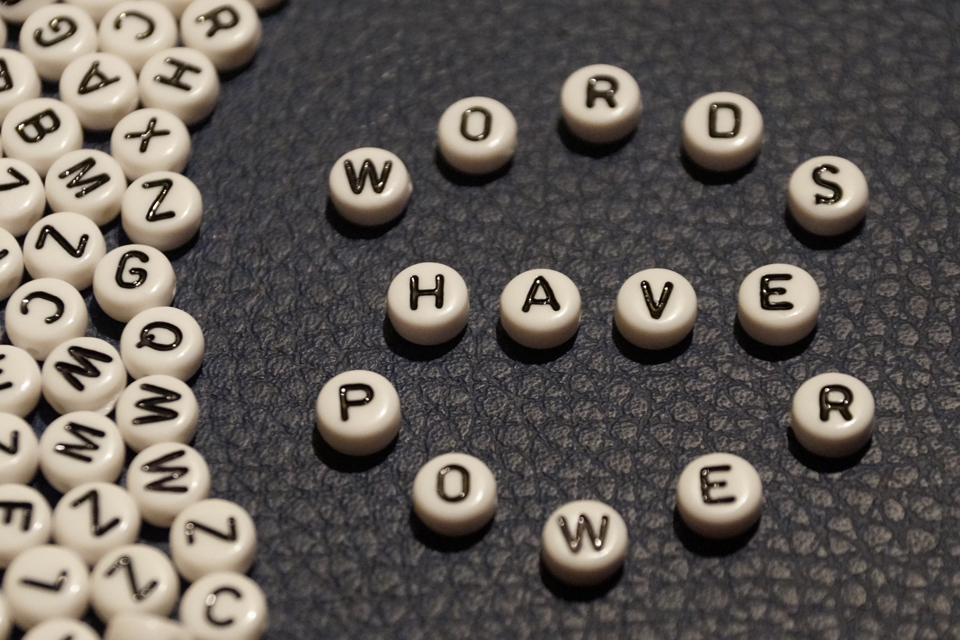 Several beads with letters on them, with beads in center spelling out &quot;Words have power&quot;.