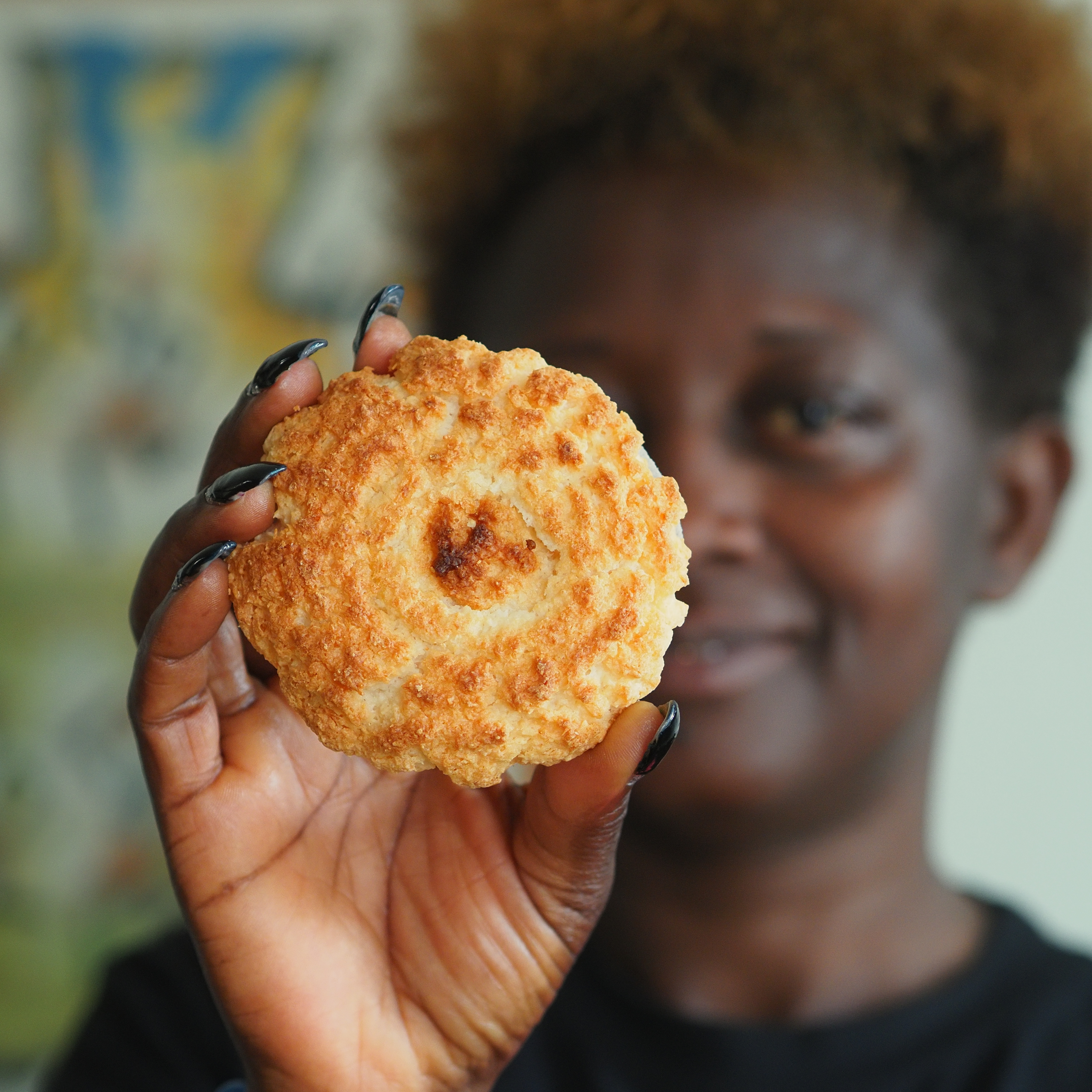 Eliane holding a sweet biscuit.