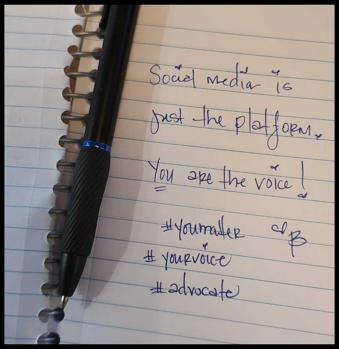 Notebook and pen with message that says "Social media is just the platform. You are the voice".