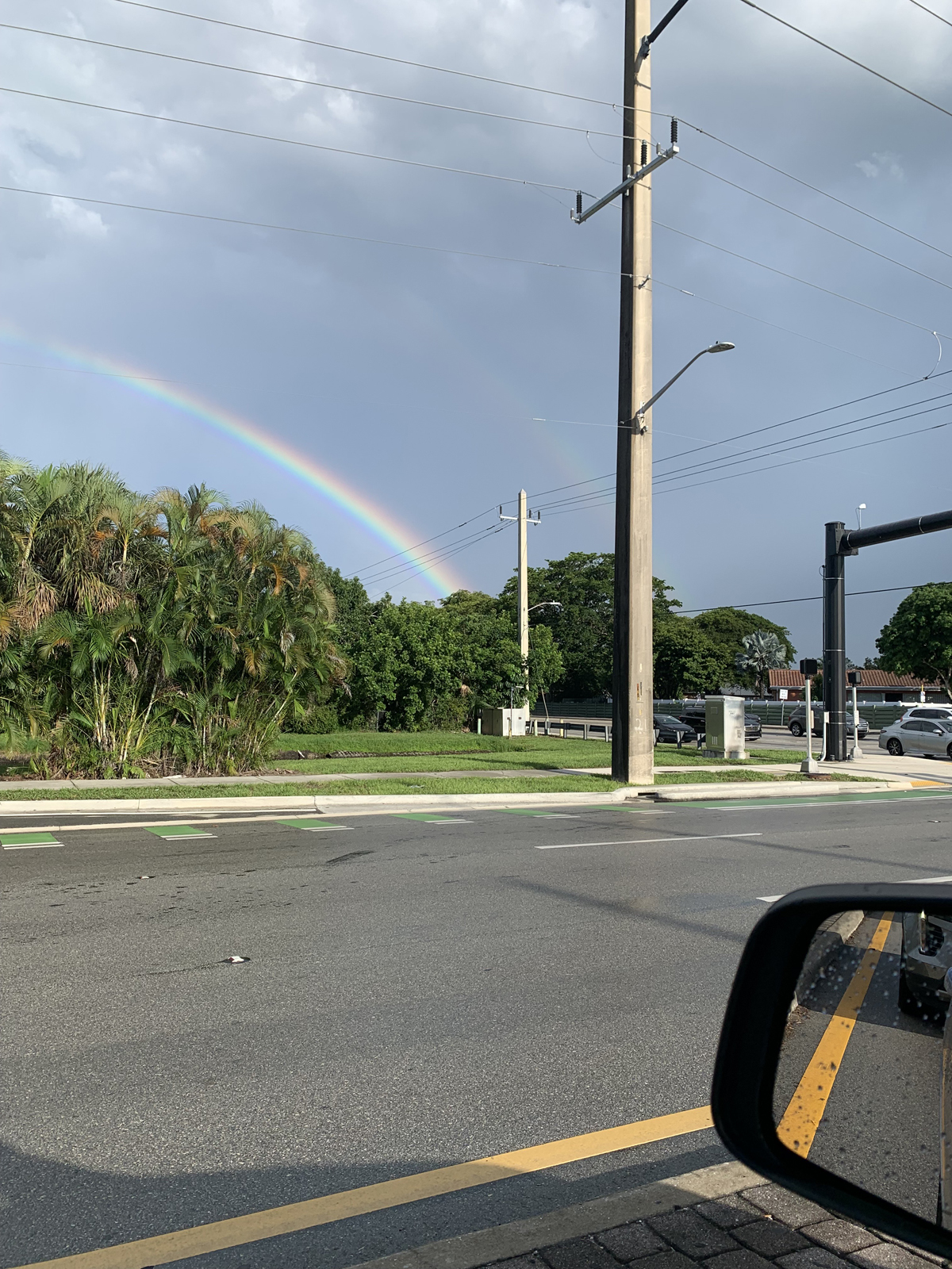 Rainbow viewed out a car window.