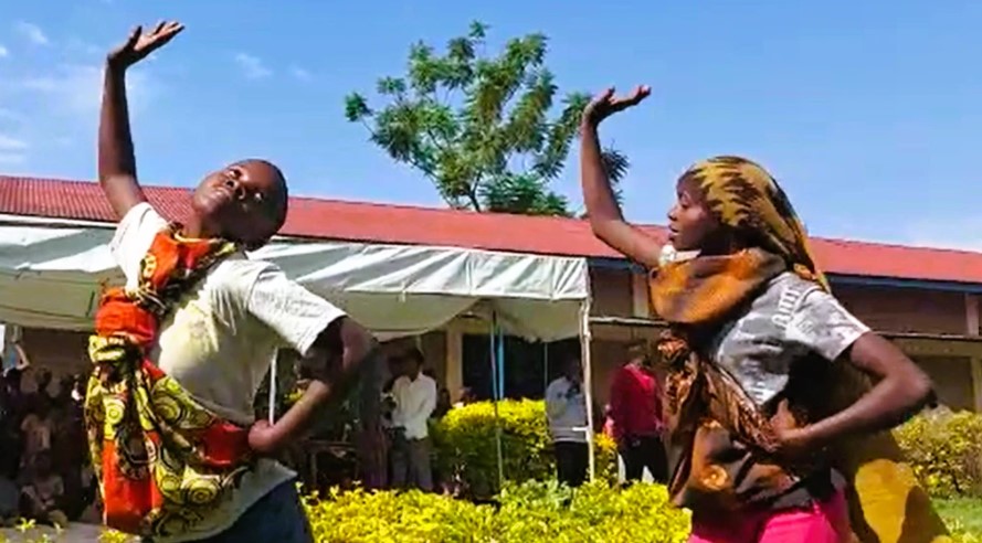 Two people dancing outside.