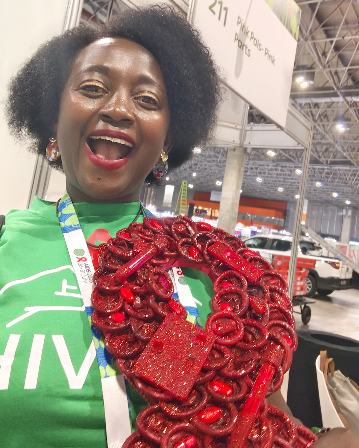 A Girl Like Me blogger Eliane (“HIVstigmafighter”) holding a large red ribbon.