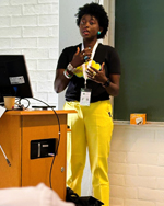 Eliane speaking in a room.