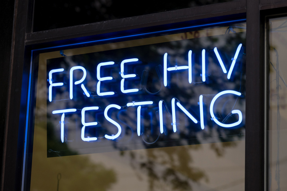 A blue neon sign that reads &quot;Free HIV testing&quot;.