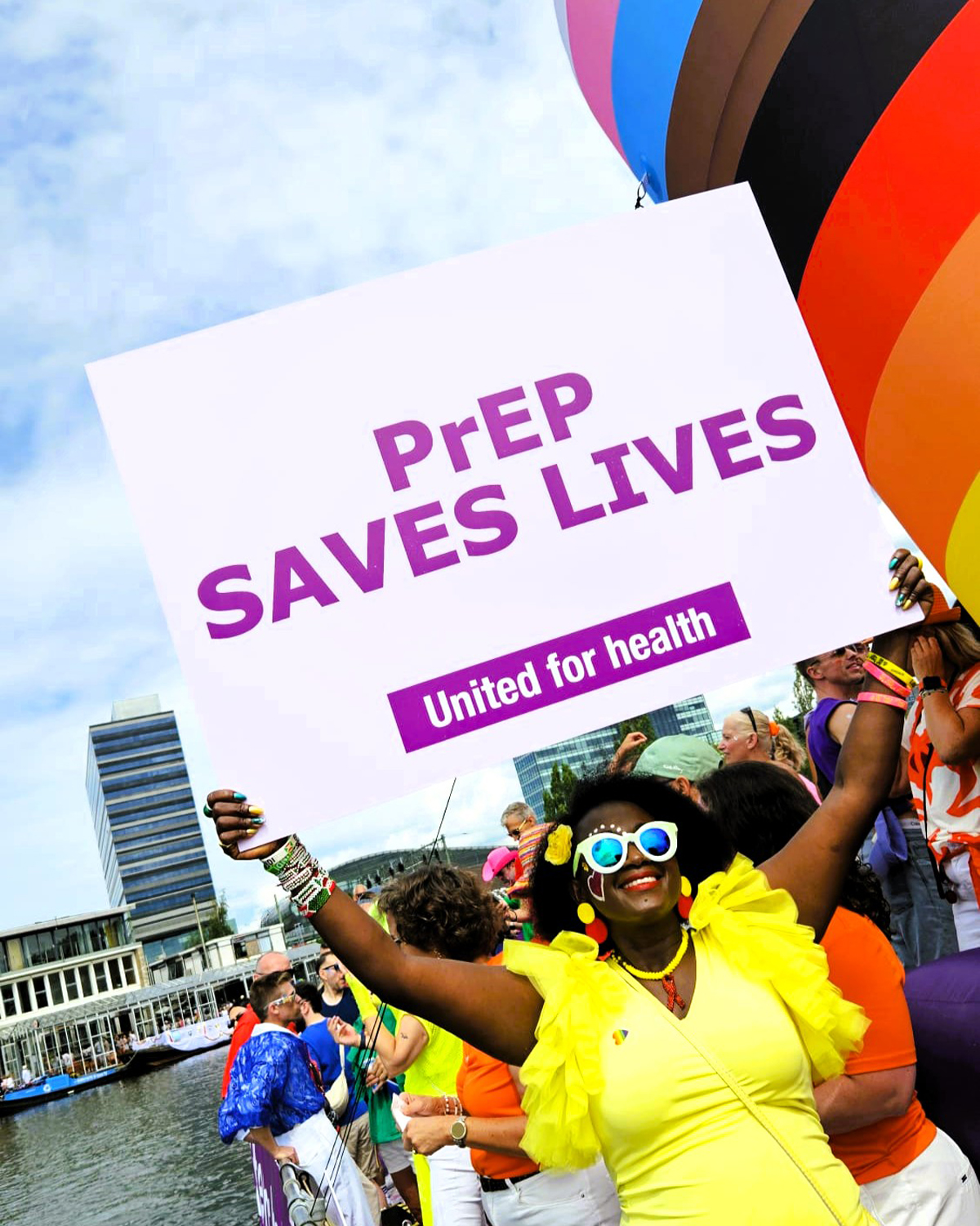 A Girl Like Me blogger Eliane ("HIVstigmafighter") holding sign that says "PrEP SAVES LIVES" United for health.