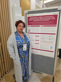 Bridgette Picou standing next to the Language Matters poster.