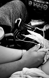 Two people holding hands with fingers entwined.