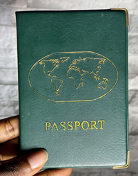 Fingers holding a passport.