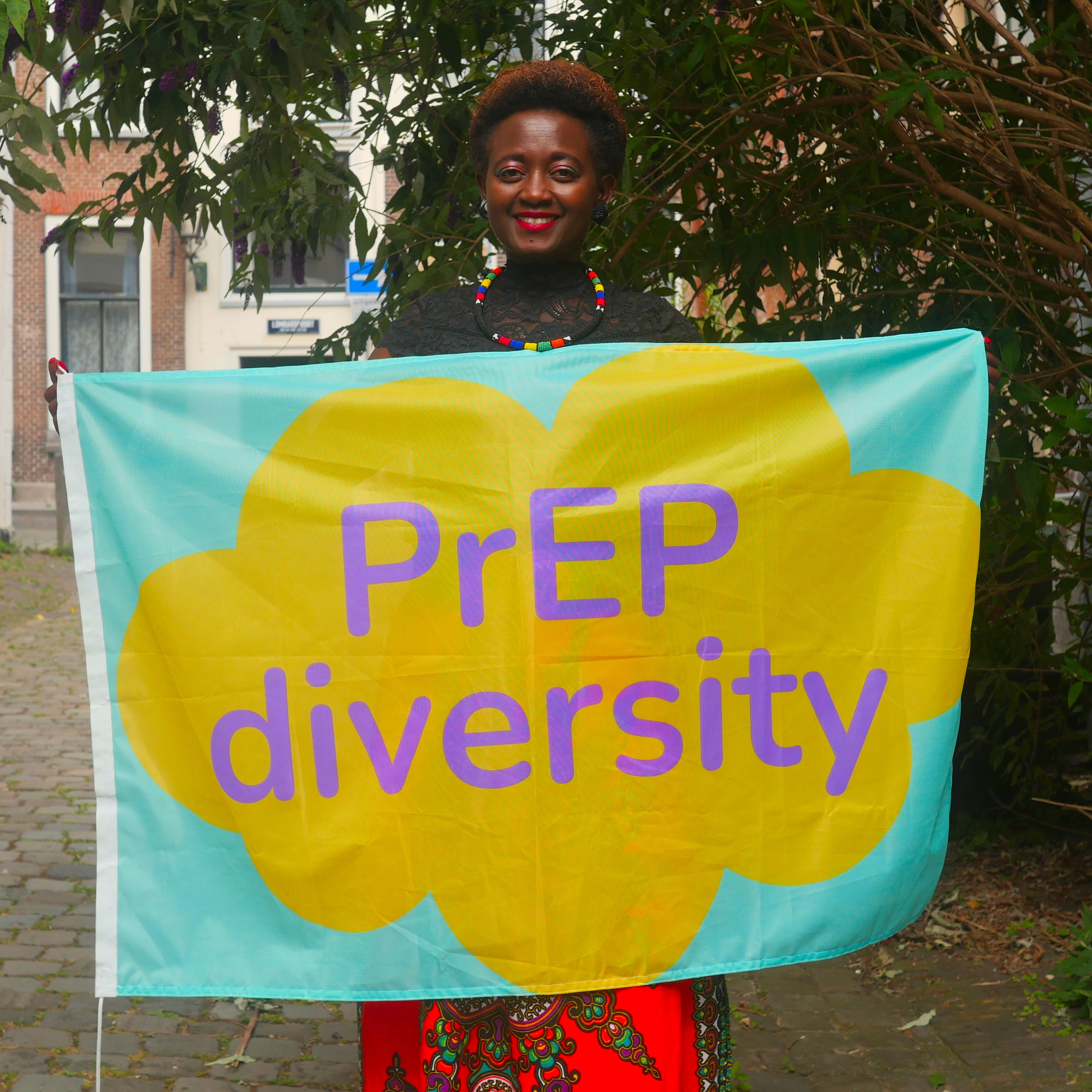 Eliane (HIVstigmafighter) holding a sign that reads &quot;PrEP Diversity&quot;.