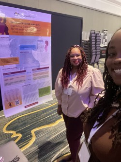 Bridgette Picou and Ciarra &quot;Ci Ci&quot; Covin with poster at ANAC 2022.