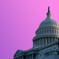 United States capitol building with a pink-purple sky. 