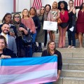 Arianna Lint & Arianna's Center staff and supporters hold trans flag at Florida State Capital.