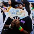 Blogger Eliane holding a fan in front of her face.