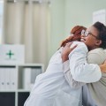Medical Provider and patient hugging.
