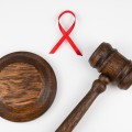 Judicial gavel and red ribbon on a white background.