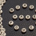 Several beads with letters on them, with beads in center spelling out "Words have power".