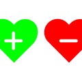 Green heart with a plus sign inside it next to a red heart with a minus mark inside it.