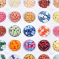 Several bowls of different colored medications in rows.