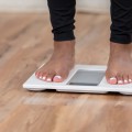 Bare feet standing on a digital scale.