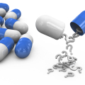 Several capsules, one with question marks spilling from it.