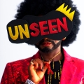 Eliane as Eric the Dragking with a mask over her eyes that reads "Unseen"..