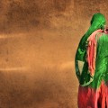 Back of woman in sari walking past a wall.