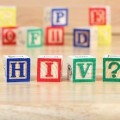 Colorful lettered baby blocks with some spelling out "H I V ?"