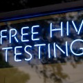 A blue neon sign that reads "Free HIV testing".