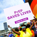 A Girl Like Me blogger Eliane ("HIVstigmafighter") holding sign that says "PrEP SAVES LIVES" United for health.