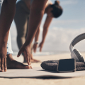Two women stretching at the beach.