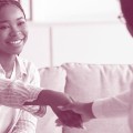 Woman shaking hands with a healthcare provider.