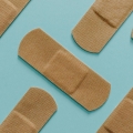Several band-aids on a blue background.