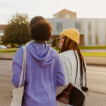 Two teenage girls walking together.