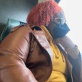 A Girl Like Me blogger Kimberly Canady sitting on a train with a mask on, looking out the window.