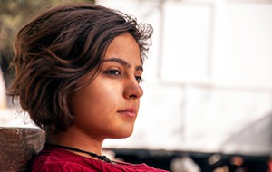 Woman looking away thoughtfully.