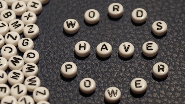 Several beads with letters on them, with beads in center spelling out "Words have power".