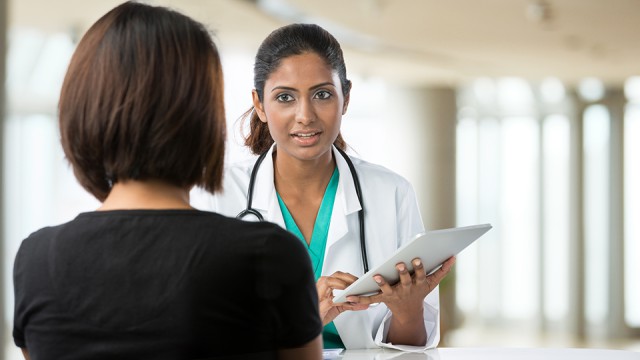 Medical professional talking to a woman. 
