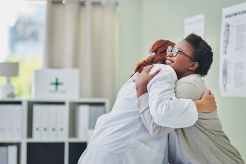 Medical Provider and patient hugging.