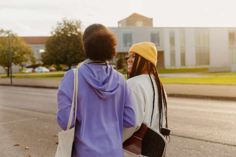 Two teenage girls walking together.