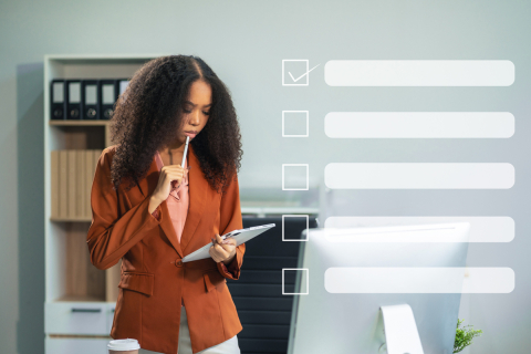 Woman looking at tablet in an office with a checklist superimposed on top of the image.